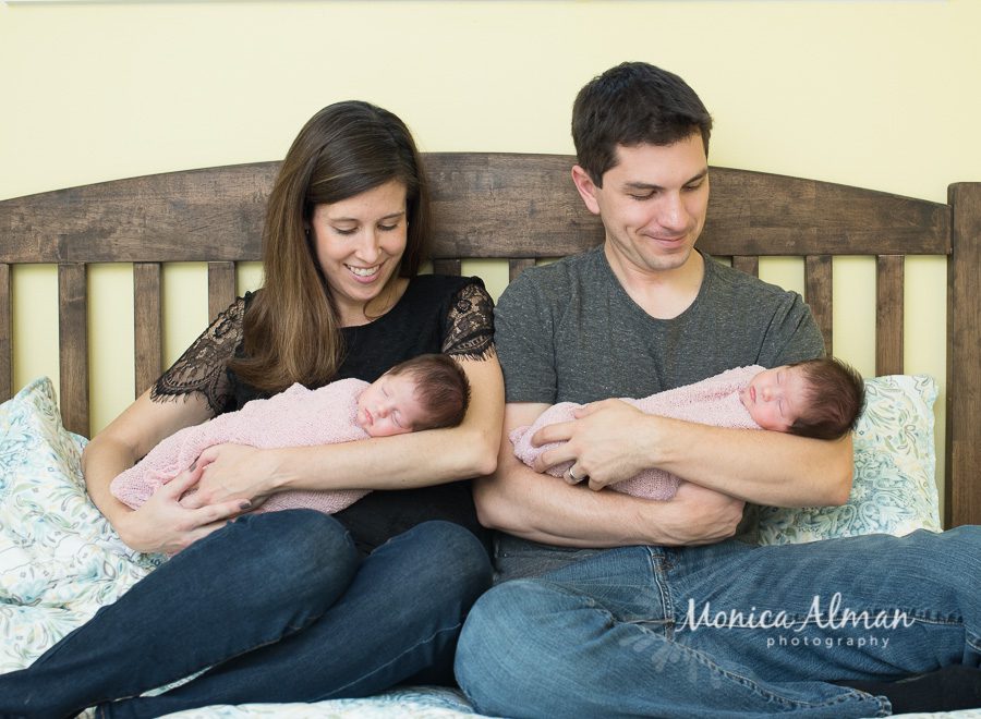 Twin Newborn Session Parents Looking at Babies Photo