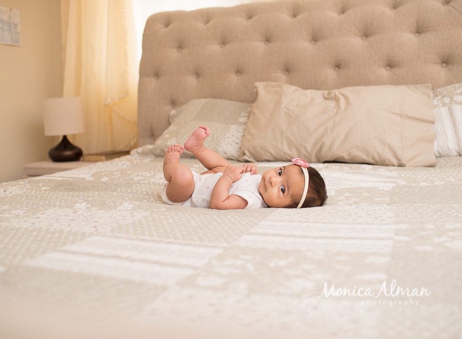 Two Month Old Baby Girl On Big Bed Photo