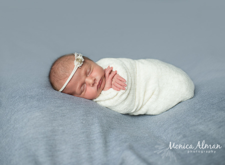 Sleeping Baby Girl Wrapped Up in Cream Blanket Photo