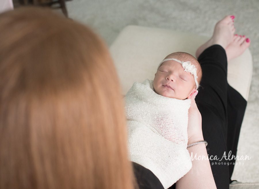 Beautiful Newborn Baby Girl Mom Looking at Baby Photo