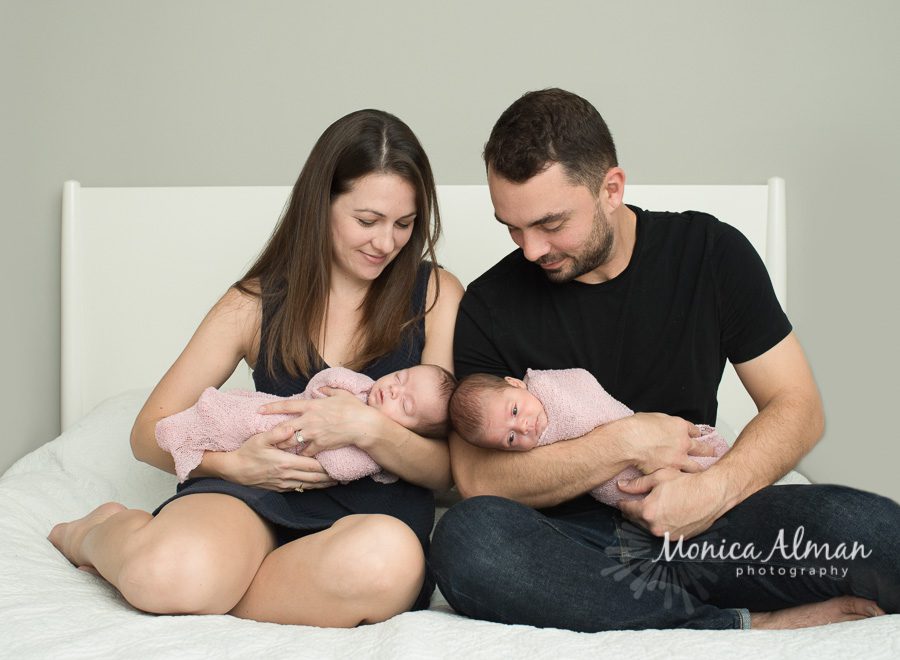 Twin Sisters Parents Looking At Babies Photo