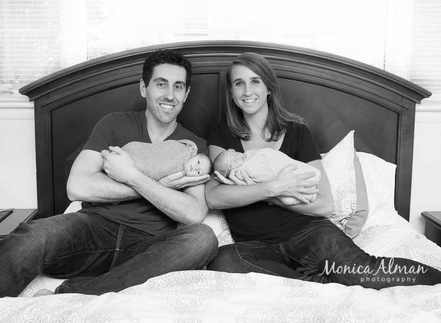 Baby Boy and Girl Twins Holding Babies on Bed Photo