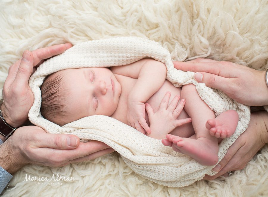 Ten-day-old-baby-boy-in-parents-hands-photo