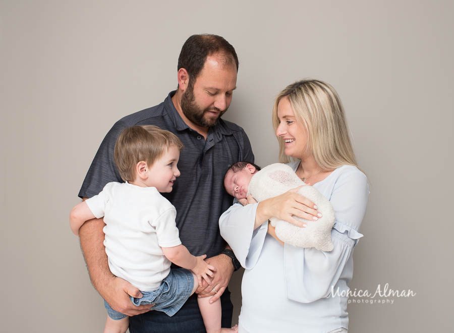 Gaithersburg Baby Photographer Family Looking At Baby Photo