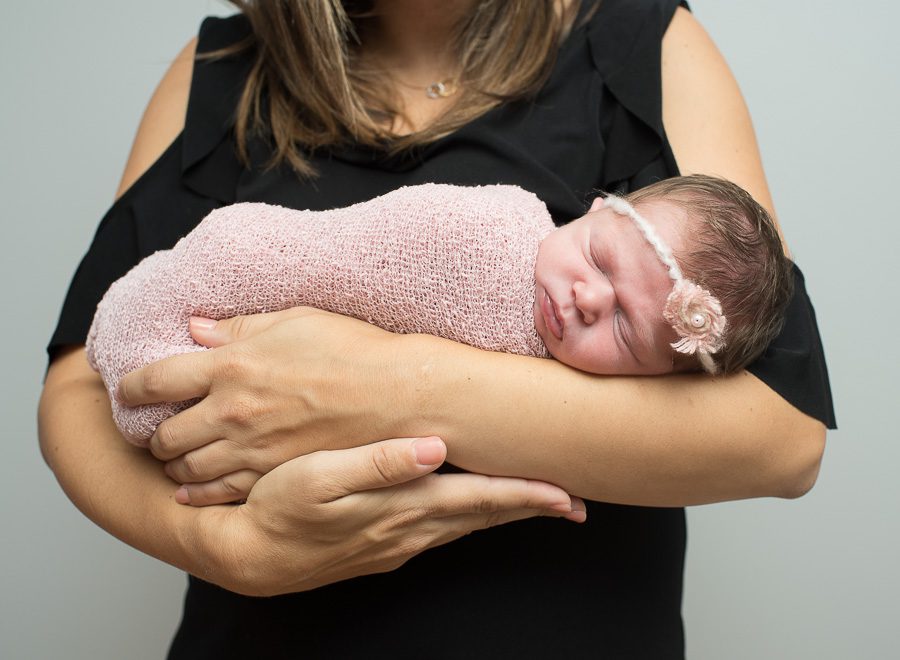 Baby Sister Snuggling in Moms Arms