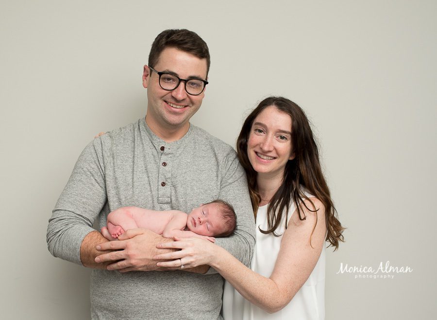 neutral portrait newborn session parents smiling photo