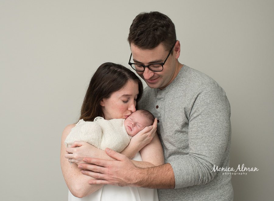 neutral portrait newborn session mom kissing baby photo