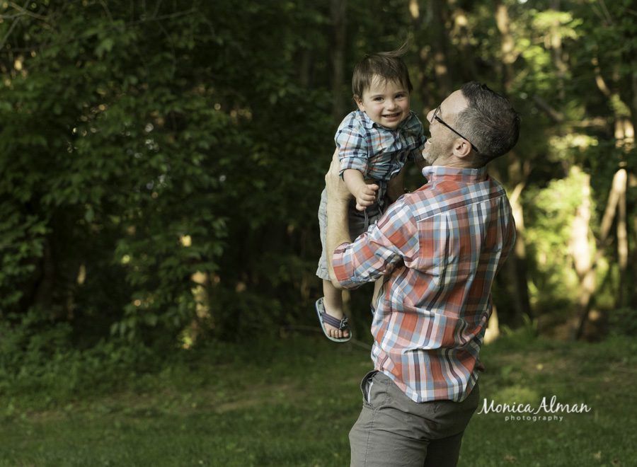 Spring Family Portraits dad throwing son up in the air