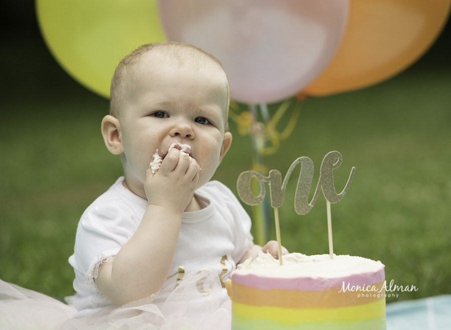 outdoor cake smash feeding herself photo