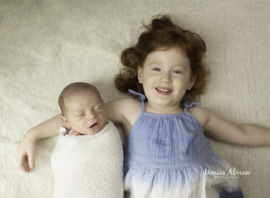 big sister holding big brother photo
