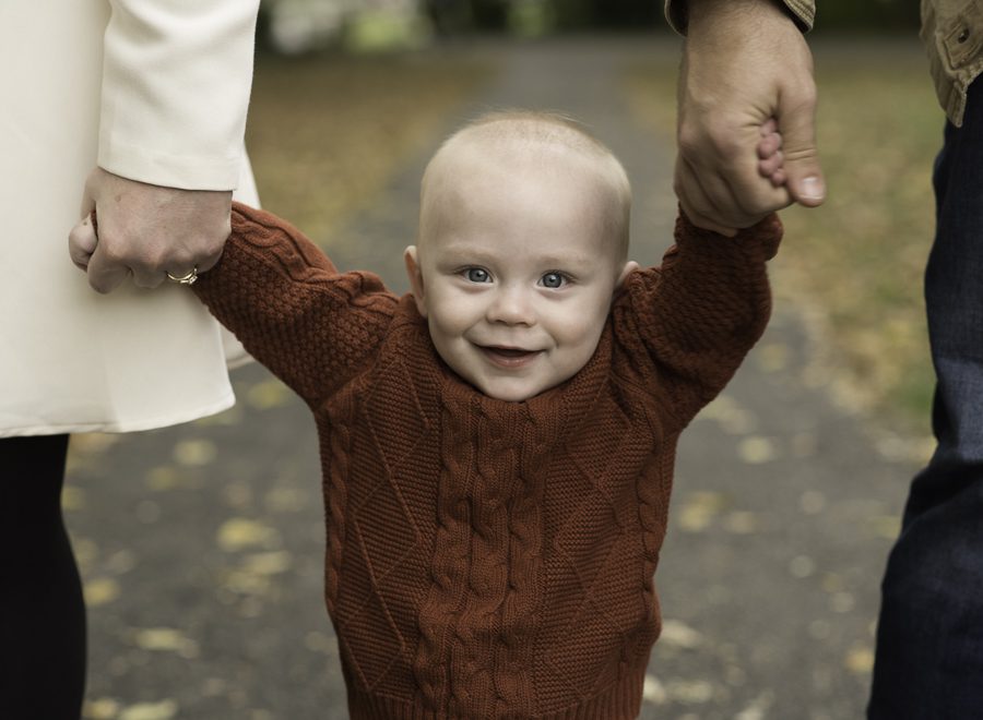 baby holding parents hands photo