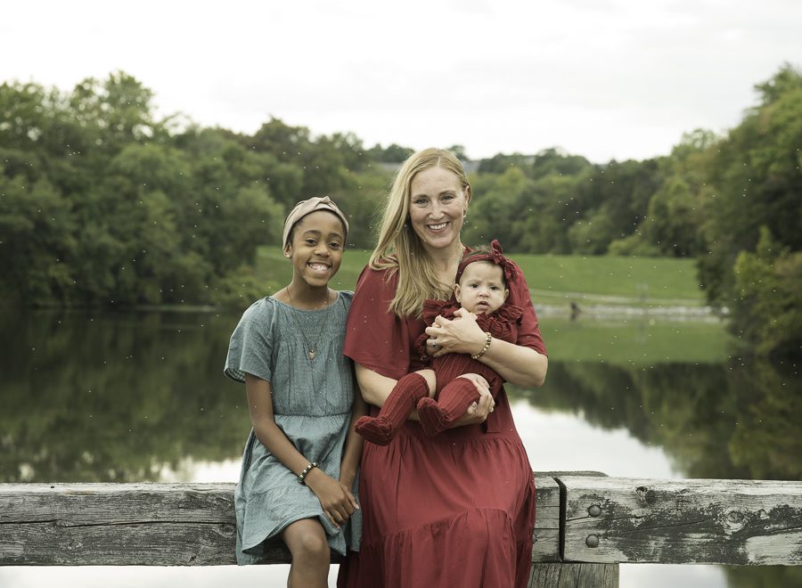 mom smiling with daughters