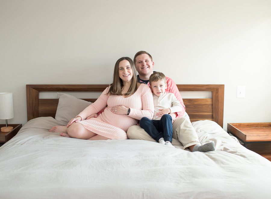 pregnant mom with family on bed photo