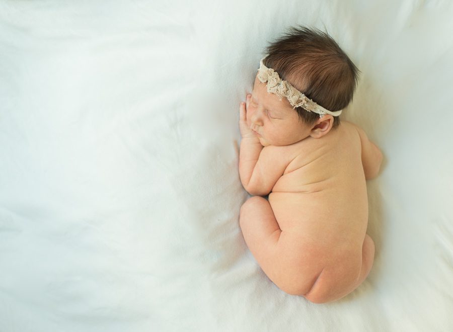 photo of newborn baby on white blanket