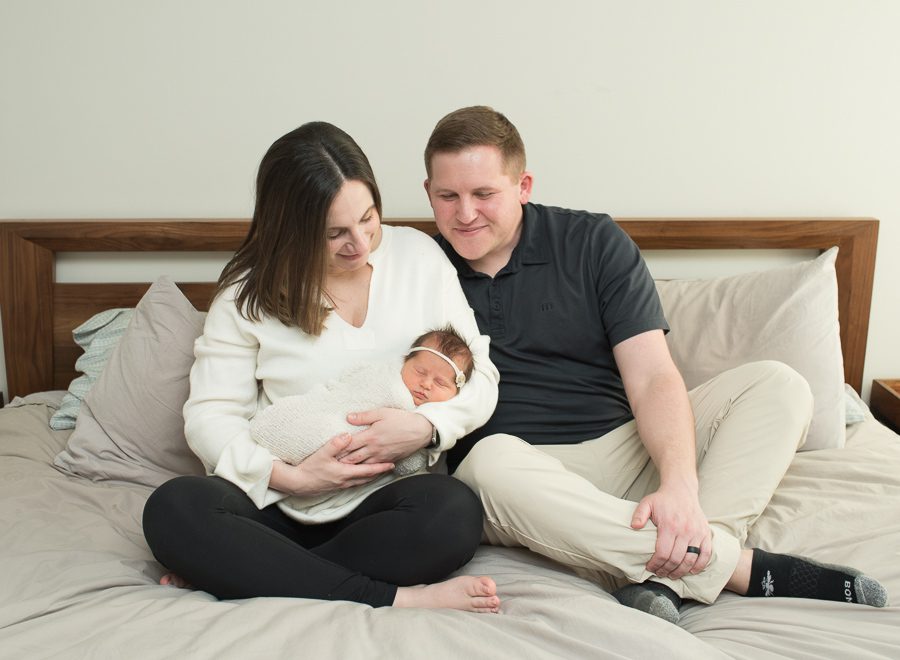 mom and dad looking at their new baby
