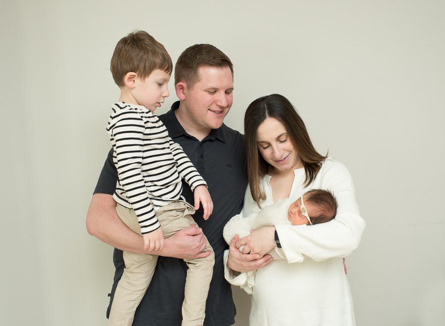 family looking at newborn baby