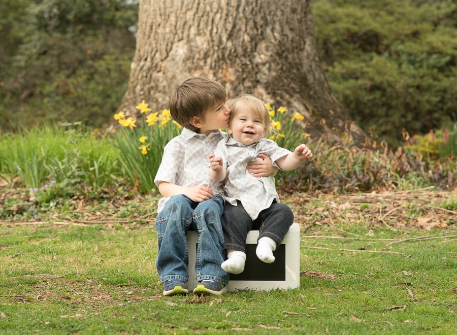 Older brother kissing younger brother in Maryland