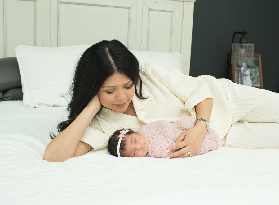 mom and baby girl on bed photo
