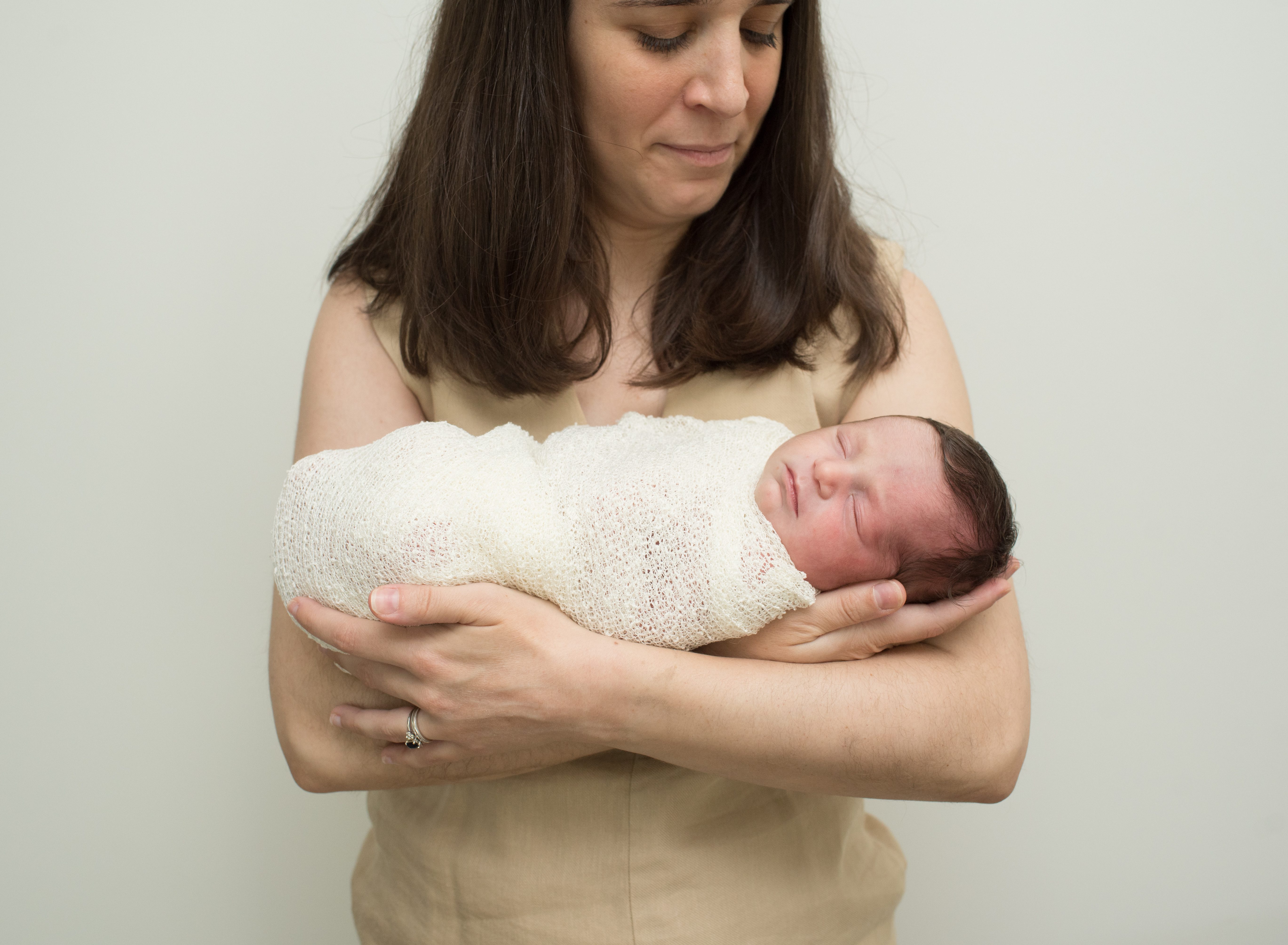 new mom looking at baby photo