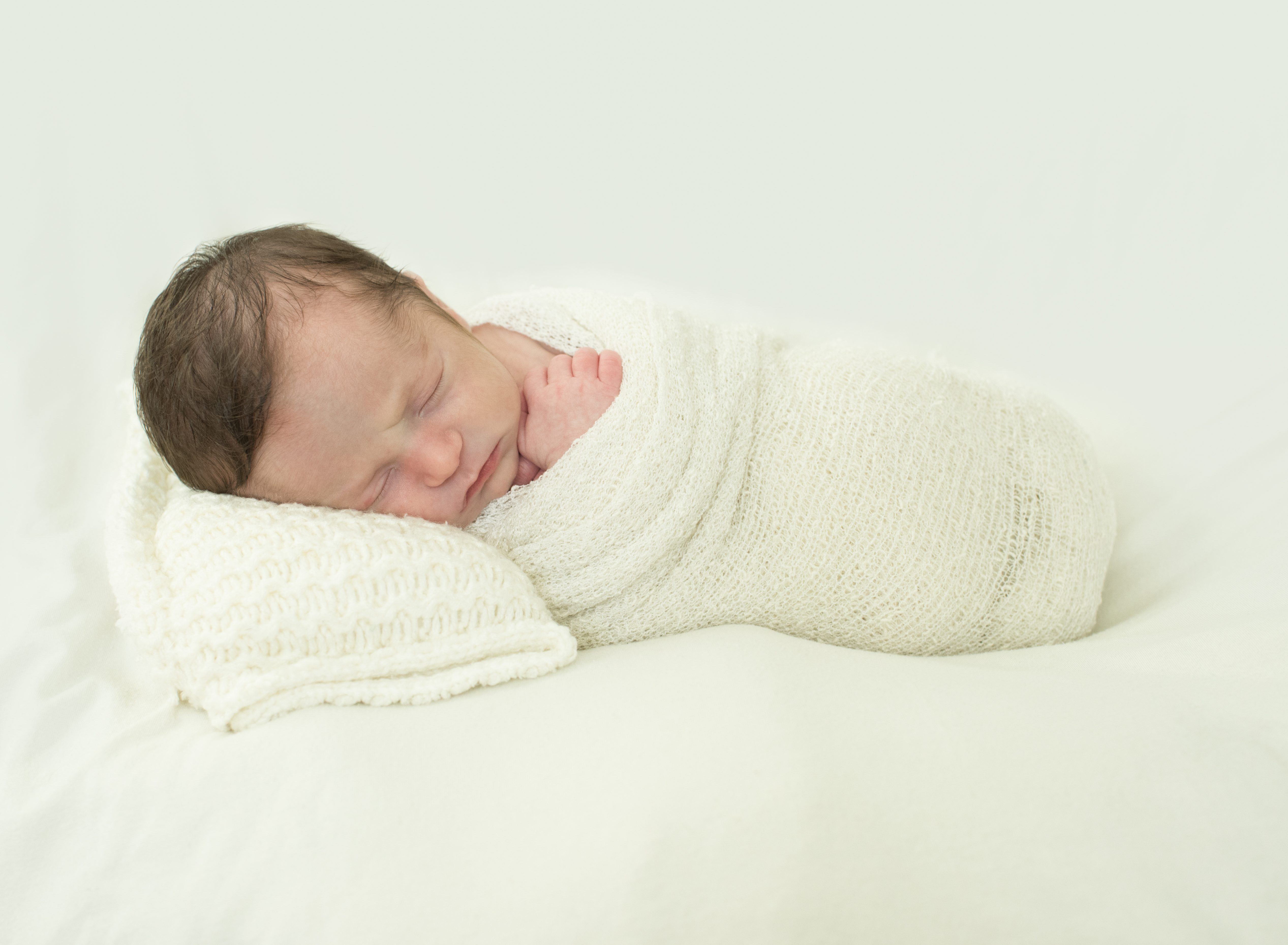 newborn baby boy on pillow