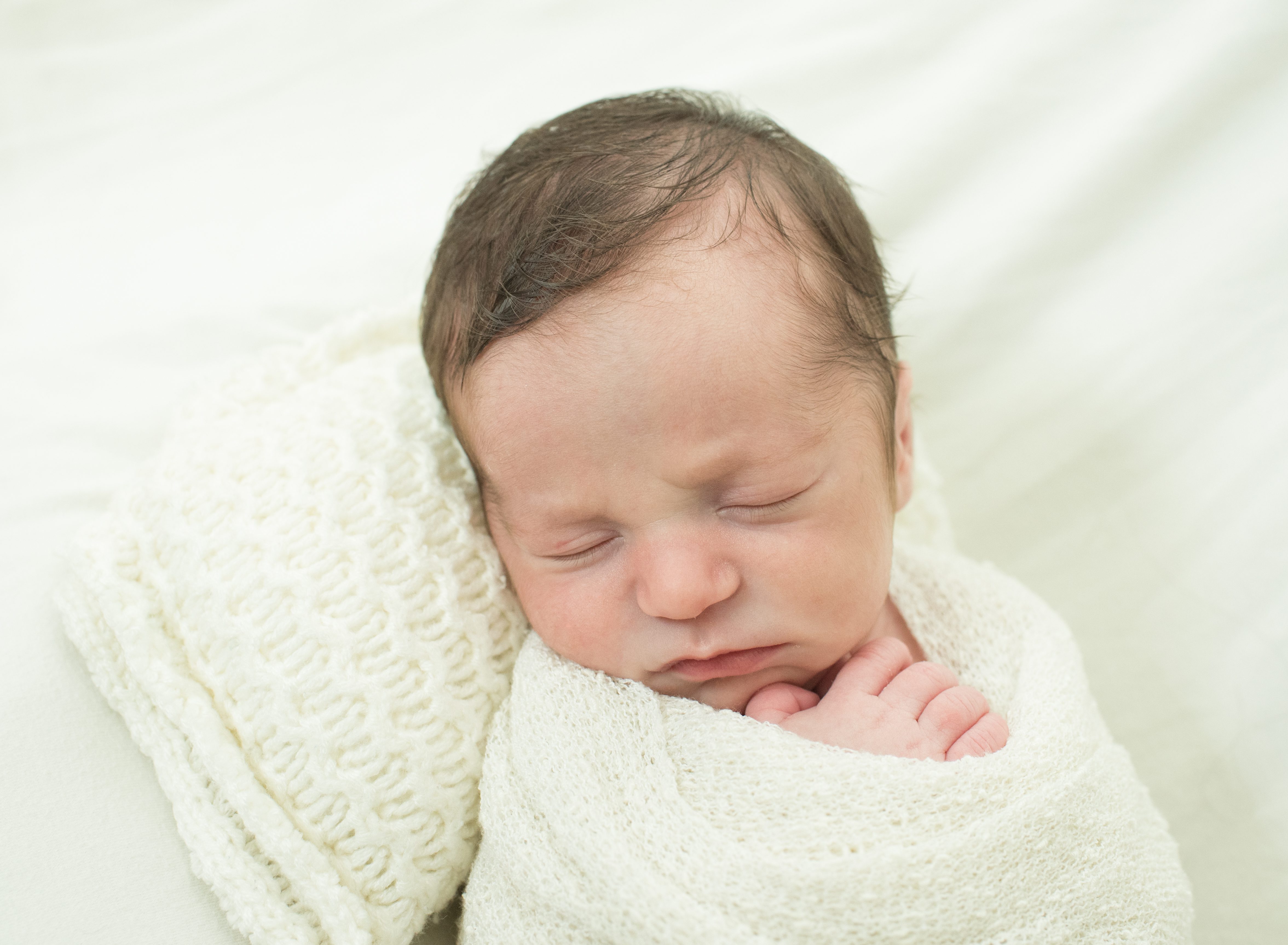 Sleepy baby on a pillow photo