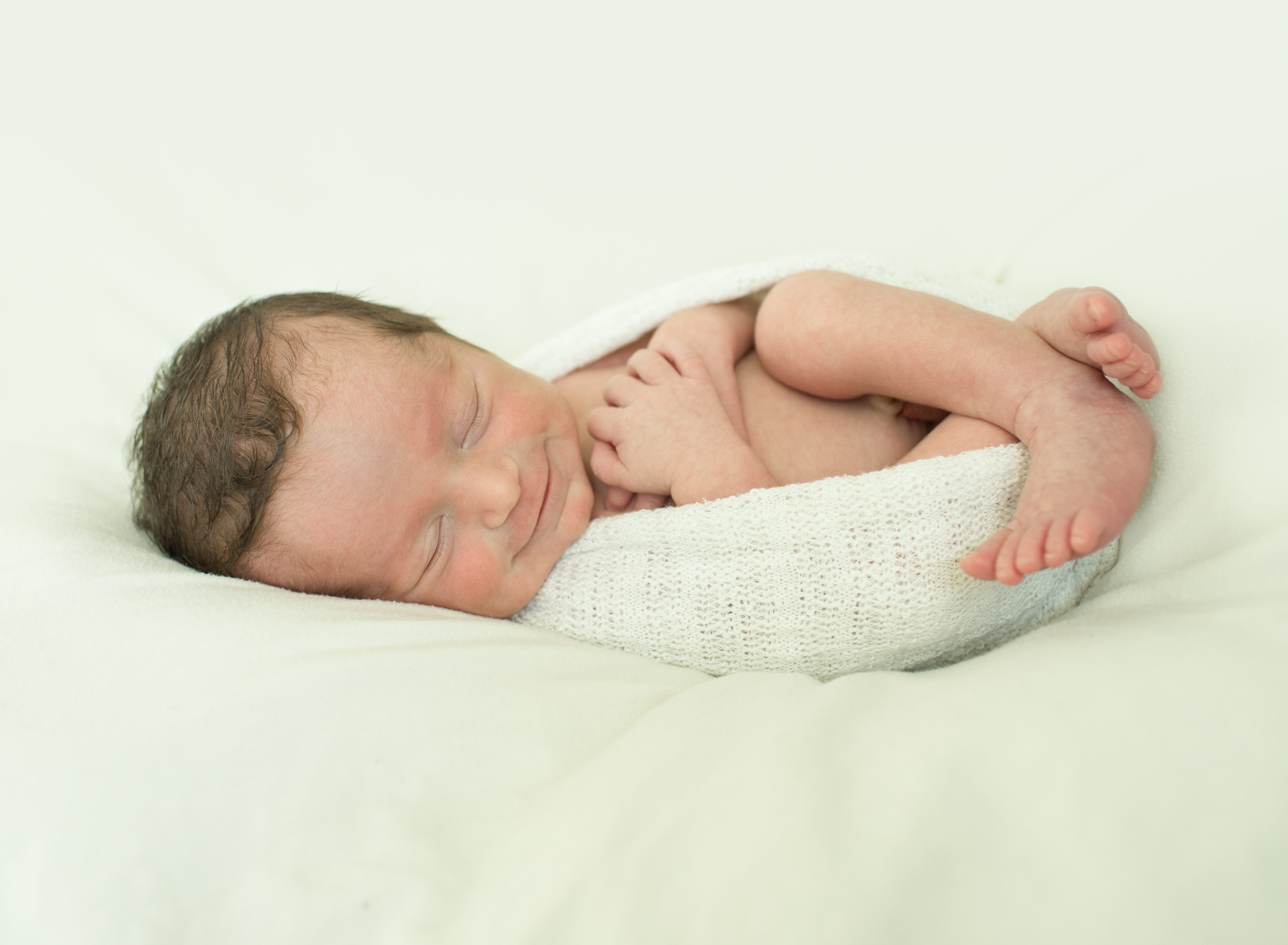 smiley baby portrait on blanket