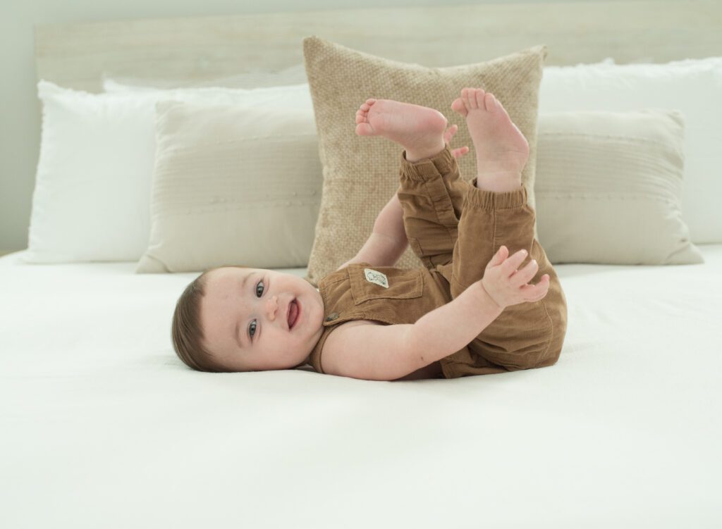 baby playing with his feet photo