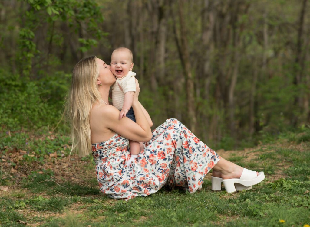 mom kissing 6 month old baby
